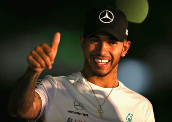 Lewis Hamilton waves to fans during Japanese qualifying. Pic: Charles Coates/Getty Images