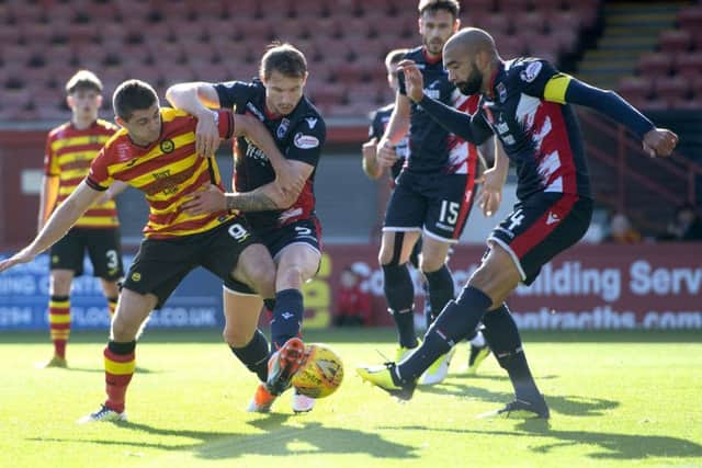 Partick Thistles Kris Doolan faces Ross County defenders. Pic: SNS/Bill Murray