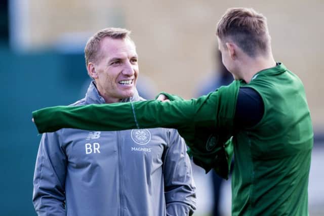 Celtic manager Brendan Rodgers speaking to Scott Allan - one of the fringe players expected to leave in January. Picture: SNS/Bill Murray
