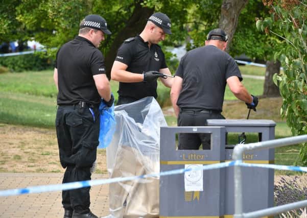 Police at the scene after the attack for which Dr Alexander Mishkin, inset, is said to be a suspect. Picture: PA