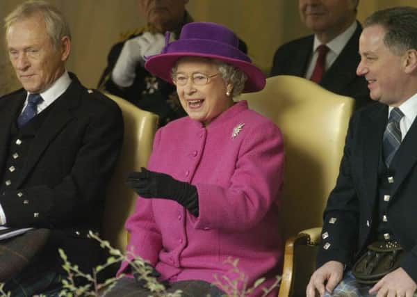 Queen Elizabeth II with George Reid, left, Presiding Officer of the Parliament and First Minister Jack McConnell observing the 'Riding' procession on the Royal Mile on Saturday, October 9 2004, part of the ceremonies to mark the opening of the Scottish Parliament at Holyrood PIC: PA Rota.