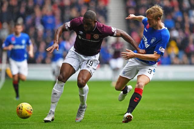 Hearts striker Uche Ikpeazu, left, has enjoyed some physical battles with opposing defenders. Picture: SNS