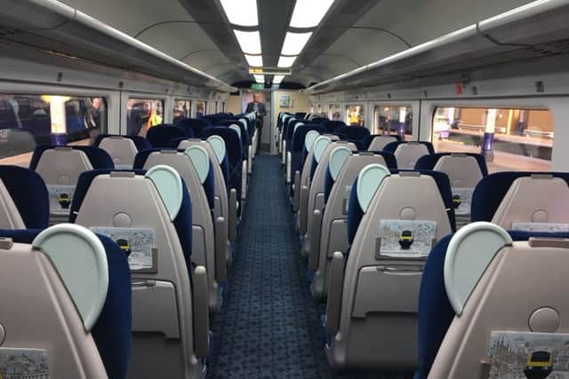 Inside the standard class carriage with passengers offered more seats, more leg room and more space for luggage.