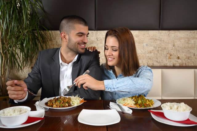 Happy young couple sharing a meal in a restaurant