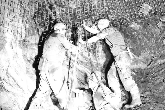 Miners work in the heat of the Lady Victoria coal mine, some 2,000 feet below Newtongrange, Midlothian, in 1958