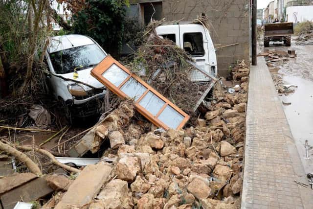 Wreckage of cars and debris lay on a street in Sant Llorenc des Cardassar, on the Spanish Balearic island of Majorca, on October 10, 2018. Picture: Getty Images