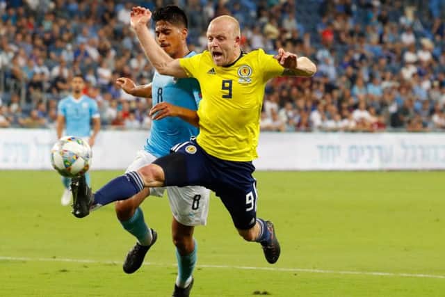 Steven Naismith is fouled to win a penalty - but it was downhill for the Scots after Charlie Mulgrew opened the scoring. Picture: AFP/Getty Images
