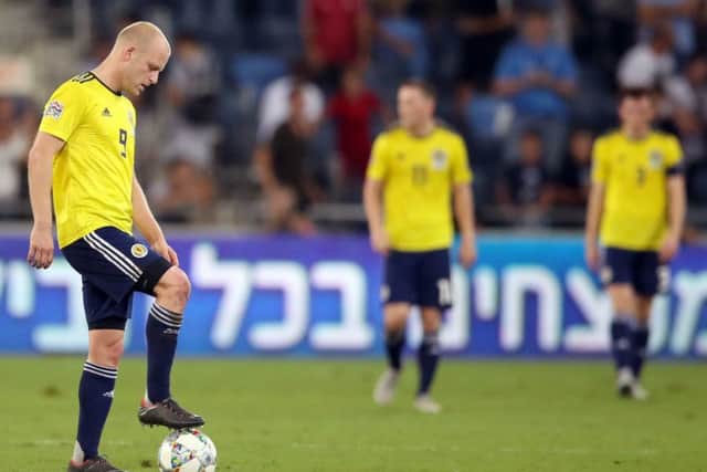Steven Naismith appears dejected after Scotland concede their second goal in the 2-1 defeat in Israel. Picture: PA