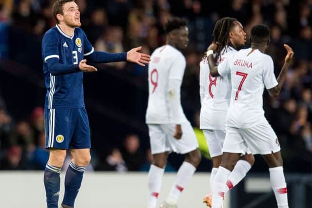 Scotland captain Andrew Robertson is dejected after Portugal make it 3-0. Picture: SNS