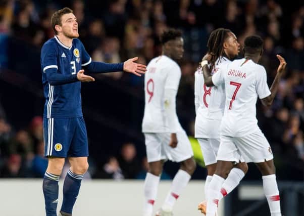 Scotland captain Andrew Robertson is dejected after Portugal make it 3-0. Picture: SNS