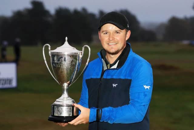 Eddie Pepperell shows off his trophy after winning the British Masters. Picture: Getty