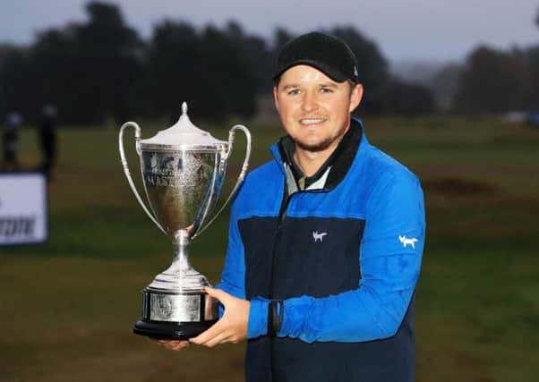 Eddie Pepperell shows off his trophy after winning the British Masters. Picture: Getty
