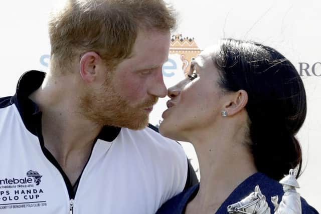 Meghan and  Prince Harry kiss during the presentation ceremony for the Sentebale ISPS Handa Polo Cup.(AP Photo/Matt Dunham, FILE)
