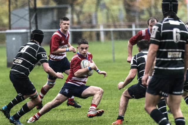 Howe fullback Ben Mitchell dodges the GHK defenders. Pic by Chris Reekie.