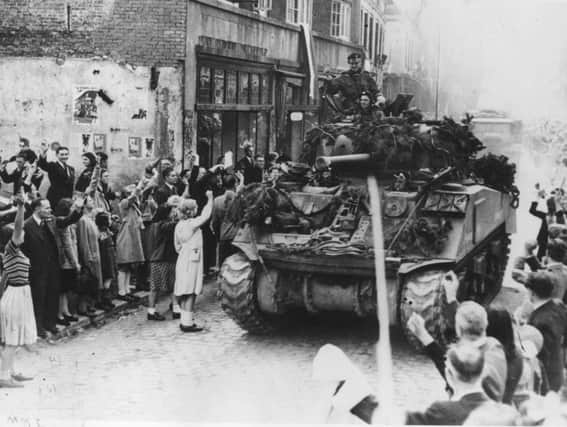 Dutch citizens cheer Britsh tanks as they liberate the country from Nazi forces in 1944 (Picture: Jack Esten/PNA Rota/Getty Images)