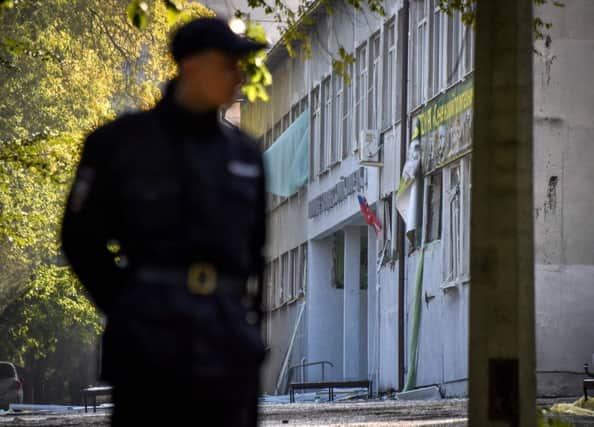 A policeman patrols in a college yard in Kerch, Crimea on October 18, 2018, after a student opened fire at a technical college in the Russian-annexed Crimea city of Kerch. - A teenage gunman shot dead at least 17 people and injured dozens before killing himself at a technical college where he was a student in Russian-annexed Crimea on October 17. (Photo by Andrey PETRENKO / AFP)ANDREY PETRENKO/AFP/Getty Images