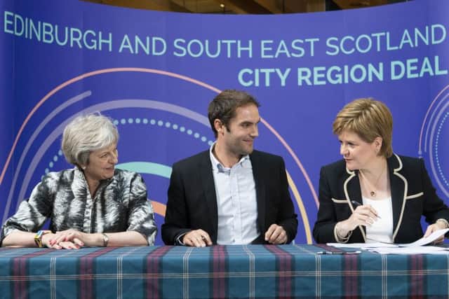 Theresa May, Adam McVey and Nicola Sturgeon at the signing of the Â£1.3bn city deal. Picture: Jane Barlow/PA Wire