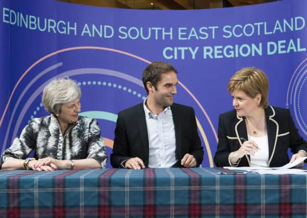 Theresa May, Adam McVey and Nicola Sturgeon at the signing of the Â£1.3bn city deal. Picture: Jane Barlow/PA Wire
