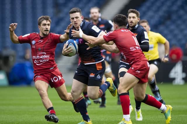 Centre Matt Scott, who was an influential figure in Edinburghs thumping win over Toulon on Saturday, breaks past Anthony Belleau. Picture: SNS/SRU