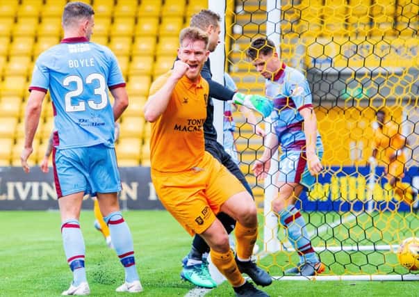 Livingston's Alan Lithgow celebrates after making it 3-0 over Dundee. Picture: SNS Group