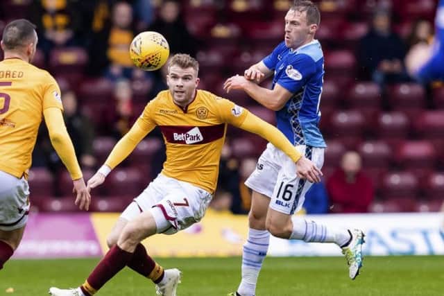 Chris Cadden (left) is challenged by St Johnstone's David Mcmillan. Picture: SNS Group