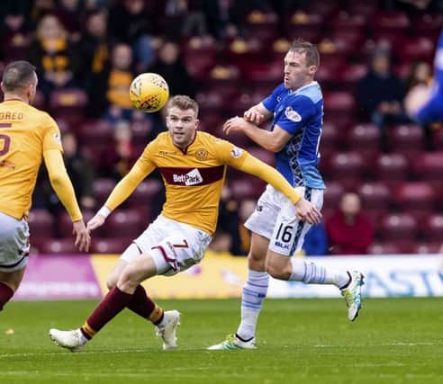 Chris Cadden (left) is challenged by St Johnstone's David Mcmillan. Picture: SNS Group