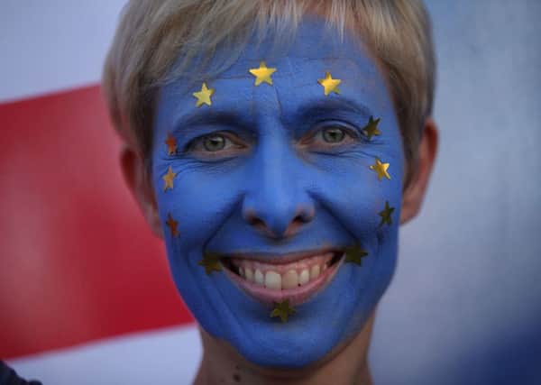 An anti-Brexit campaigner with her face painted in the colours of the European Union flag (Picture: Yui Mok/PA Wire)