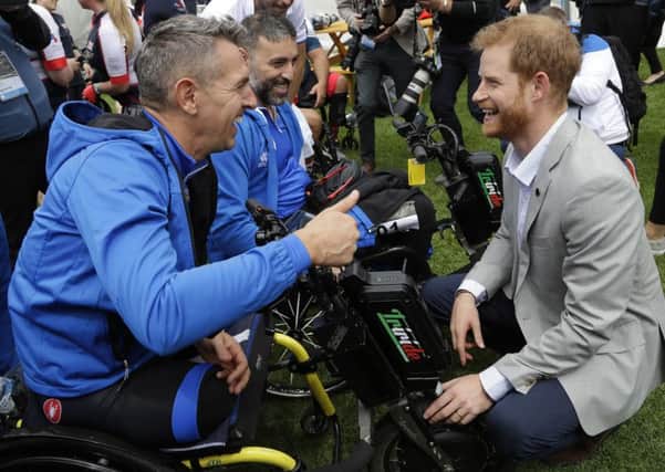 Britain's Prince Harry meets Italian competitors as he attends the Invictus Games cycling competition in Sydney, Australia. Picture: (AP Photo/Kirsty Wigglesworth)