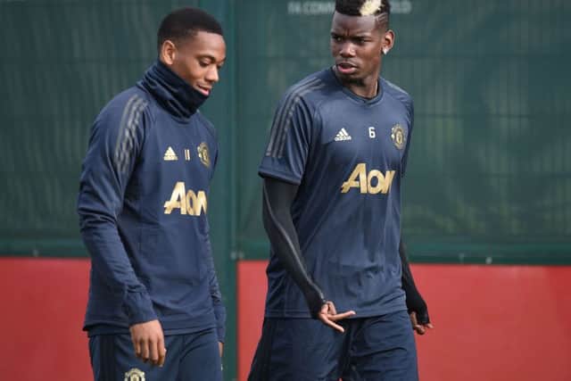 Anthony Martial, left, arrives at training yestarday with Paul Pogba, as Manchester United prepare to face Juventus. Picture: Getty