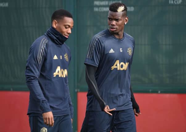 Anthony Martial, left, arrives at training yestarday with Paul Pogba, as Manchester United prepare to face Juventus. Picture: Getty