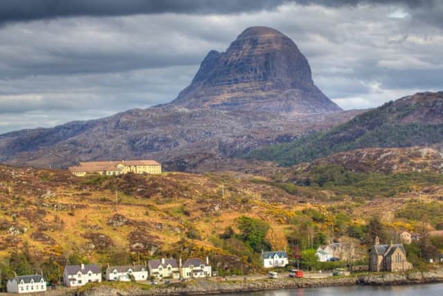 A walk up Suilven mountain - pictured here behind the pretty village of Lochinver - was listed by Lonely Planet as one of the best experiences to be had in the Highlands and Islands. PIC: Flickr/Creative Commons/Steve Bittinger.