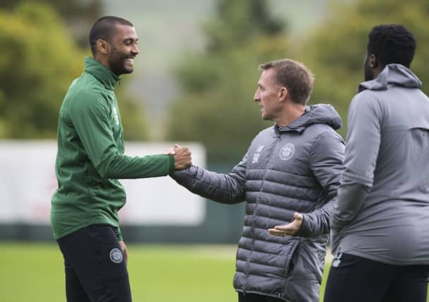 Marvin Compper, left, shakes hand with manager Brendan Rodgers during training. Picture: SNS