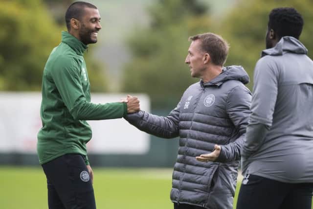 Marvin Compper, left, shakes hand with manager Brendan Rodgers during training. Picture: SNS