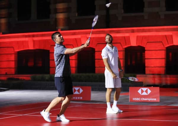 Brooks Koepka and Dustin Johnson on the same side of the net in a badminton match in Shanghai. Picture: Andrew Redington