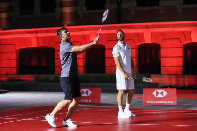 Brooks Koepka and Dustin Johnson on the same side of the net in a badminton match in Shanghai. Picture: Andrew Redington