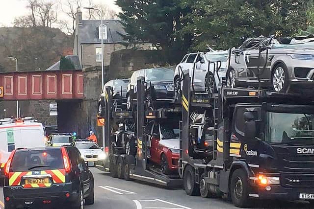 These brand new Range Rovers and a Jaguar had their roofs torn off after a lorry driver tried to drag them through a low bridge. Picture: SWNS