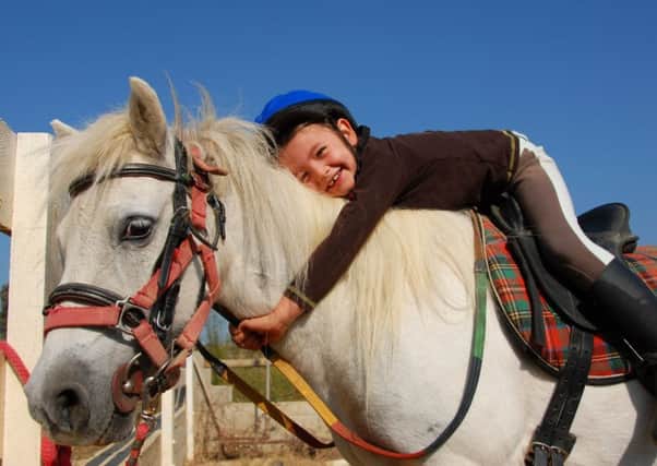 Outdoor play and aminal therapy, including caring for horses, will be central to the new schools support for traumatised children. Picture: Getty Images/iStockphoto