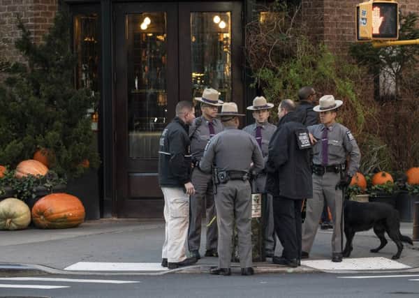 Law enforcement officials gather near the scene of where another package bomb was found early Thursday morning at Robert De Niro's Tribeca Grill restauran. Picture: Drew Angerer/Getty Images.