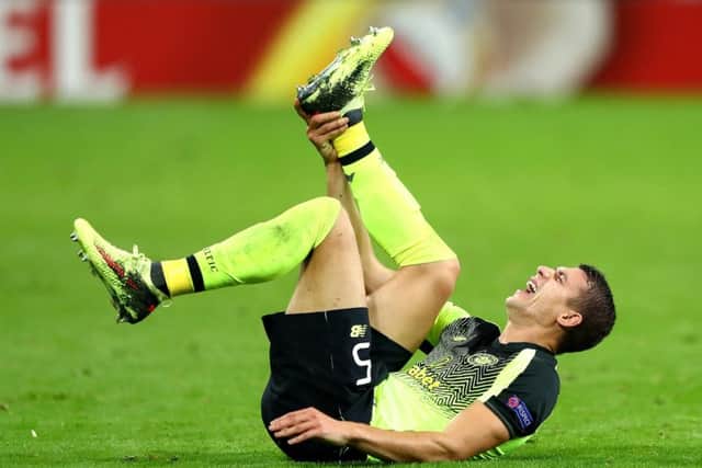 Celtic's Jozo Simunovic reacts to an ankle injury during the Europa League defeat by RB Leipzig. Picture: Martin Rose/Bongarts/Getty Images