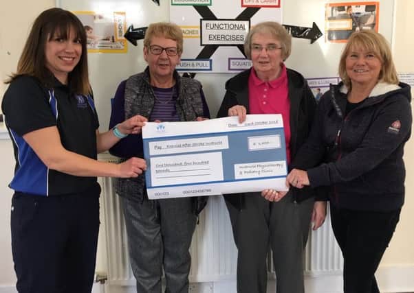 Laura Patterson presents the donation to Lorna Skea, Mary Morrision and Pam Marr of EASI