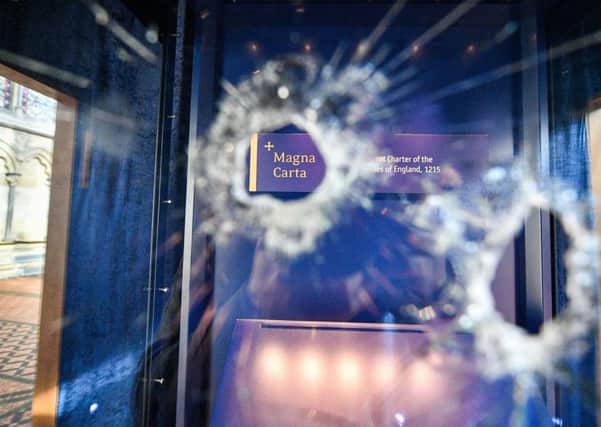 Hammer holes in the glass case that houses the Magna Carta, inside the Chapter House, at Salisbury Cathedral after a 45-year-old man has been arrested on suspicion of its attempted theft. Picture: Ben Birchall/PA Wire