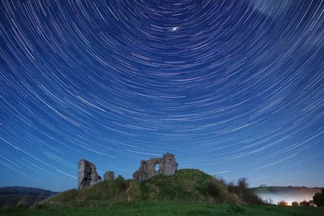 Landscape astro-photographer Nick Jackson had gone to Clun Castle, Shrops., to shoot the 13th century edifice in front of the night sky to make a 'star trail'. Picture: SWNS