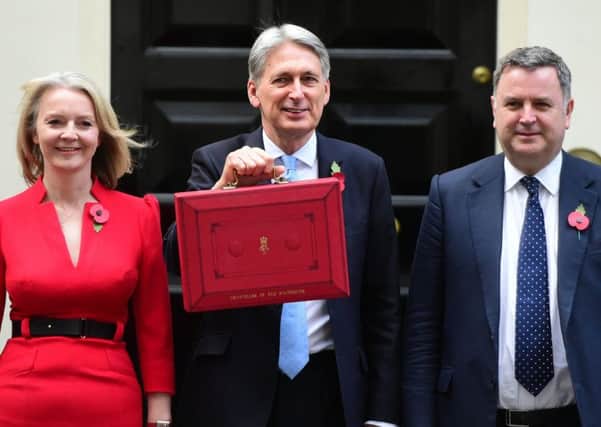 Chancellor Philip Hammond holds his red ministerial box outside 11 Downing Street, London, flanked by Treasury colleagues Liz Truss (left) and Mel Stride, before heading to the House of Commons to deliver his Budget. Picture: David Mirzoeff/PA Wire