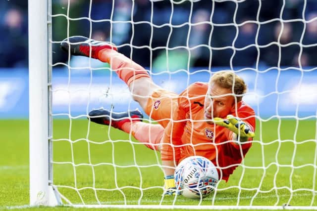 Zdenek Zlamal attempts to claw the ball back from his goal line as his blunder gifts Celtic their second goal. Picture: SNS.