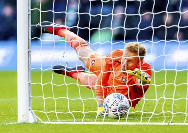 Zdenek Zlamal attempts to claw the ball back from his goal line as his blunder gifts Celtic their second goal. Picture: SNS.