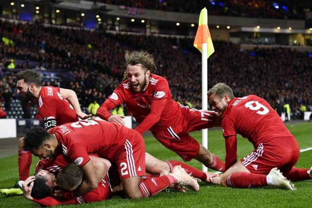 Aberdeen's players mob Lewis Ferguson after his 79th-minute winner. Picture: SNS Group