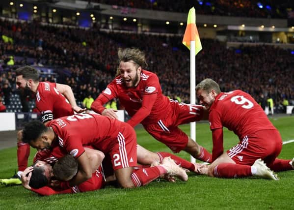 Aberdeen's players mob Lewis Ferguson after his 79th-minute winner. Picture: SNS Group