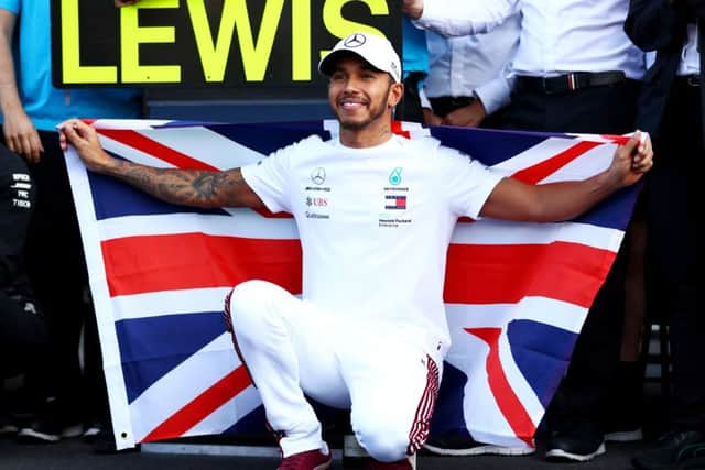 Lewis Hamilton proudly flies the Union Jack after clinching the Formula 1 world title in Mexico City on Sunday. Picture: Getty.