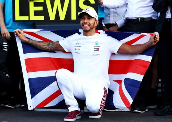 Lewis Hamilton proudly flies the Union Jack after clinching the Formula 1 world title in Mexico City on Sunday. Picture: Getty.