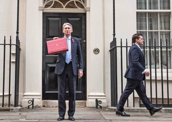 Chancellor Philip Hammond holding his red ministerial box outside 11 Downing Street before heading to the House of Commons to deliver his Budget. (Picture: Stefan Rousseau/PA)